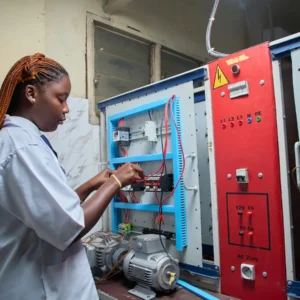 Technician wiring contactors and circuit breakers in an industrial electrical control panel