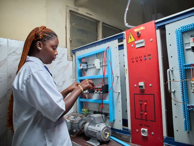 Technician wiring contactors and circuit breakers in an industrial electrical control panel