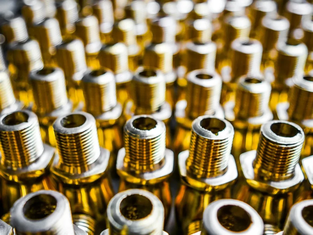 Rows of threaded hydraulic adaptor fittings in close-up
