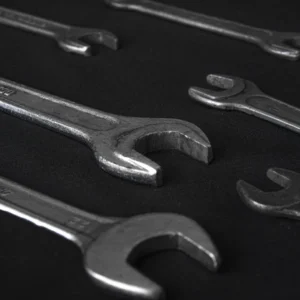 Heavy-duty forged steel open-end wrenches on a dark background